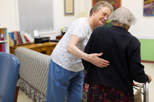 Caregiver helping a woman