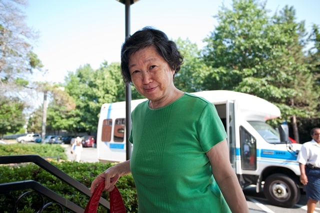 Photo of elderly woman in a green shirt